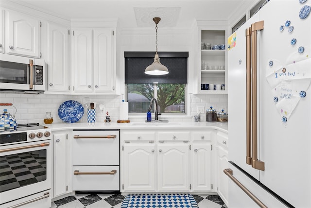 kitchen with a sink, white appliances, backsplash, white cabinetry, and light countertops