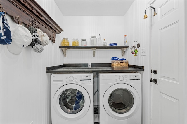 washroom featuring separate washer and dryer and laundry area