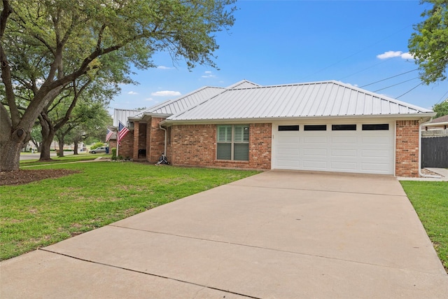 ranch-style home featuring a front yard, driveway, an attached garage, and brick siding