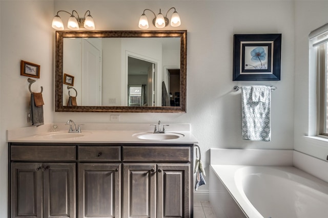 full bathroom featuring double vanity, a garden tub, plenty of natural light, and a sink