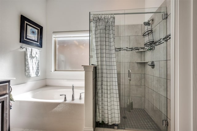 bathroom with a stall shower and a bath
