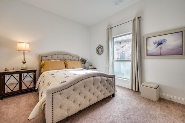 bedroom with visible vents, baseboards, and light carpet