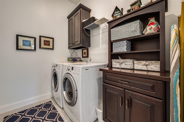 laundry room featuring light tile patterned floors, cabinet space, baseboards, and washer and clothes dryer