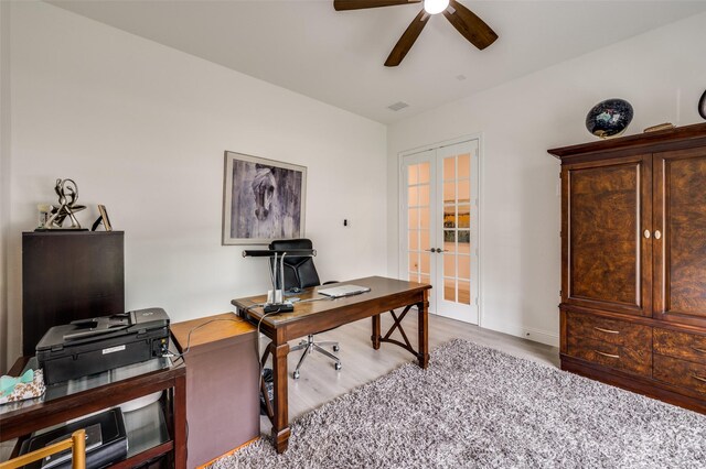 office featuring ceiling fan, french doors, visible vents, baseboards, and wood finished floors