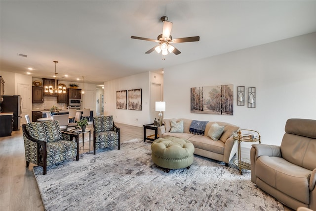 9525 Blue Stem Ln, Little Elm, TX 75068 - living room with a chandelier, a ceiling fan, light wood-style floors, and recessed lighting