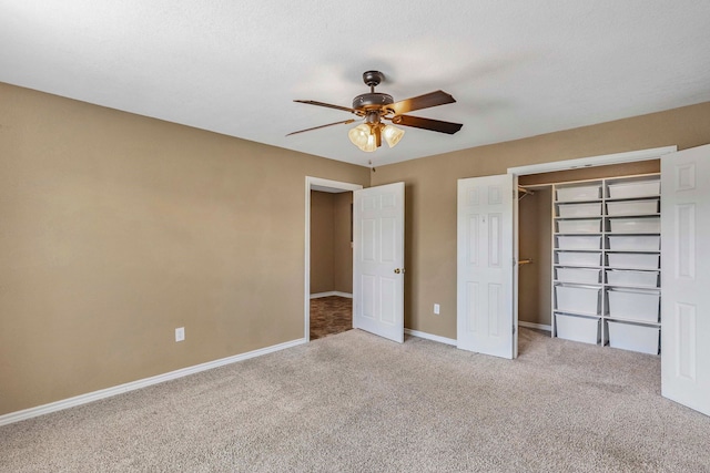unfurnished bedroom with a ceiling fan, a closet, carpet, and baseboards