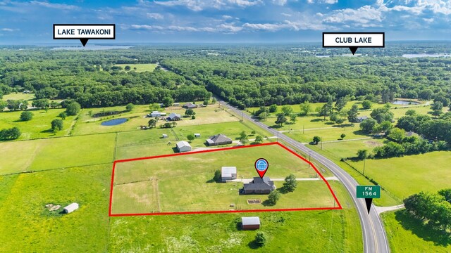 birds eye view of property with a view of trees