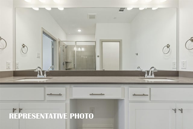 bathroom featuring a stall shower, visible vents, and vanity