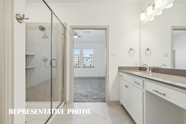 bathroom featuring tile patterned floors, a stall shower, a ceiling fan, and vanity