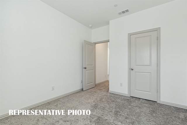 unfurnished bedroom featuring baseboards, visible vents, and carpet flooring