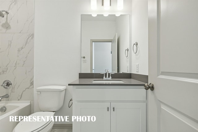 bathroom featuring toilet, shower / washtub combination, and vanity