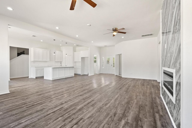 unfurnished living room with recessed lighting, a ceiling fan, visible vents, and wood finished floors