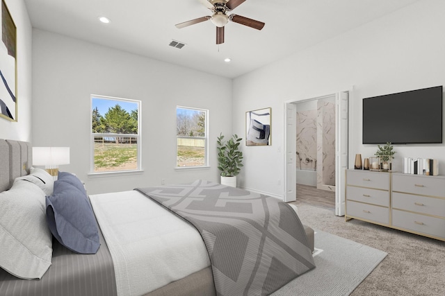bedroom featuring recessed lighting, visible vents, light colored carpet, and ensuite bathroom