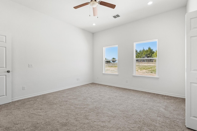 carpeted empty room with recessed lighting, a ceiling fan, visible vents, and baseboards