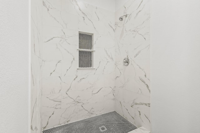 full bathroom featuring a marble finish shower