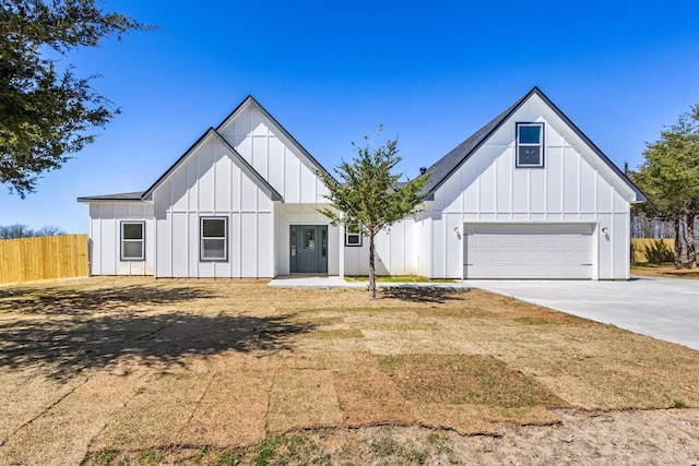 modern inspired farmhouse with fence, board and batten siding, concrete driveway, and a garage