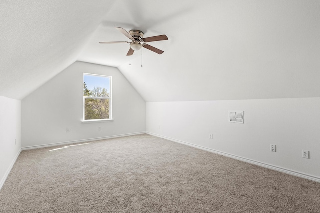 bonus room featuring baseboards, a ceiling fan, carpet floors, and vaulted ceiling