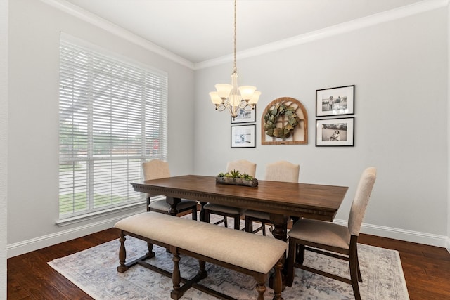 dining area featuring crown molding, baseboards, dark wood-type flooring, and a notable chandelier