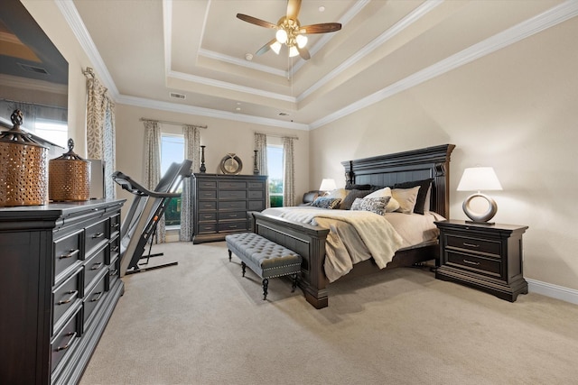 bedroom featuring visible vents, crown molding, a tray ceiling, and light carpet