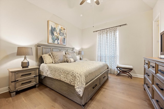 bedroom with light wood finished floors, a ceiling fan, and baseboards