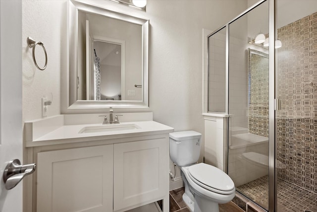 full bathroom with toilet, vanity, and a shower stall