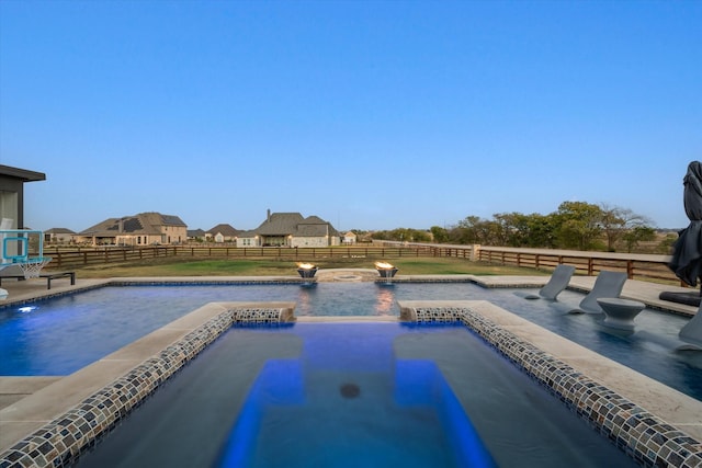 view of swimming pool featuring a fenced backyard and a pool with connected hot tub