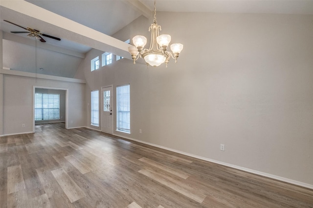 2406 Sutton Dr, Arlington, TX 76018 - empty room with high vaulted ceiling, ceiling fan with notable chandelier, beam ceiling, and wood finished floors