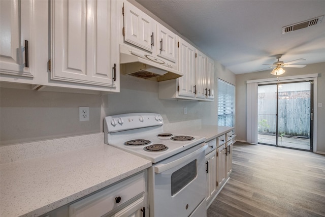 2406 Sutton Dr, Arlington, TX 76018 - kitchen featuring white electric range oven, ceiling fan, white cabinetry, under cabinet range hood, and visible vents