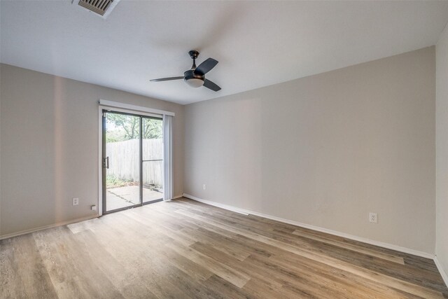 2406 Sutton Dr, Arlington, TX 76018 - spare room featuring baseboards, a ceiling fan, wood finished floors, and visible vents