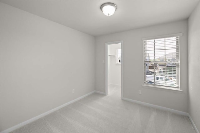 empty room featuring baseboards and carpet floors