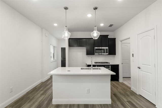 202 Griffith, Princeton, TX 75407 - kitchen featuring stainless steel microwave, a sink, recessed lighting, dark wood-style flooring, and light countertops