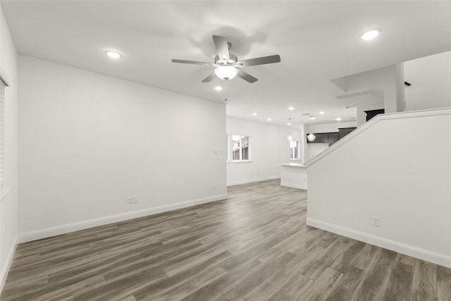 202 Griffith, Princeton, TX 75407 - unfurnished living room with ceiling fan, wood finished floors, recessed lighting, baseboards, and stairs
