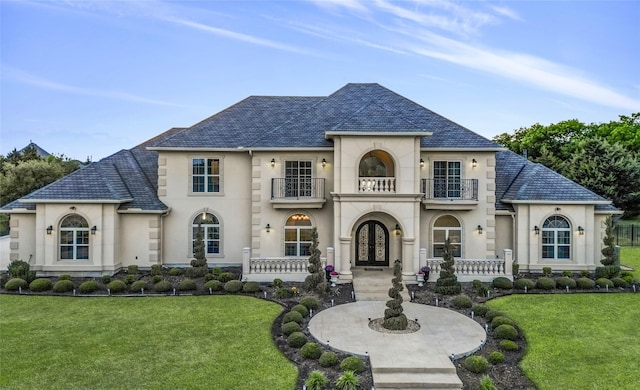 french provincial home featuring a high end roof, french doors, and a balcony