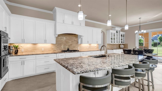 kitchen with appliances with stainless steel finishes, white cabinets, and a sink