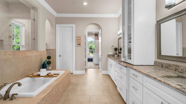 full bathroom featuring double vanity, a garden tub, crown molding, and tile patterned flooring