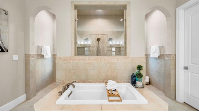 full bathroom featuring a garden tub and tile walls