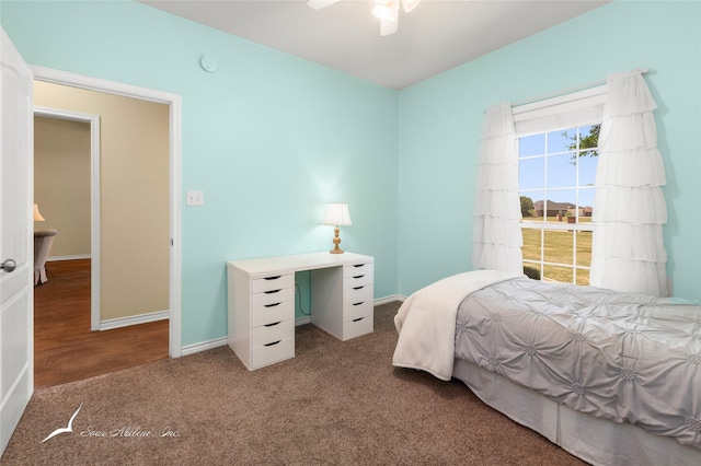 carpeted bedroom featuring ceiling fan and baseboards