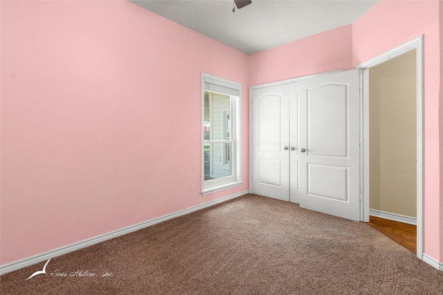 unfurnished bedroom featuring baseboards, a ceiling fan, a closet, and carpet flooring