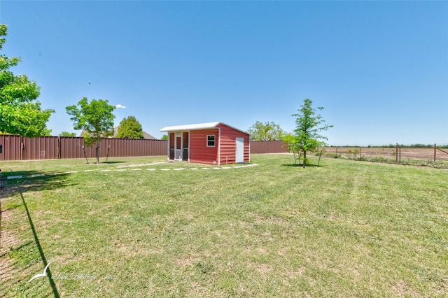 view of yard with an outbuilding and a fenced backyard