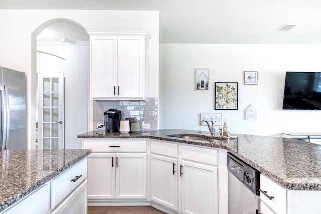 300 Copper Switch Dr, Anna, TX 75409 - kitchen with dark stone counters, decorative backsplash, stainless steel appliances, a sink, and white cabinetry