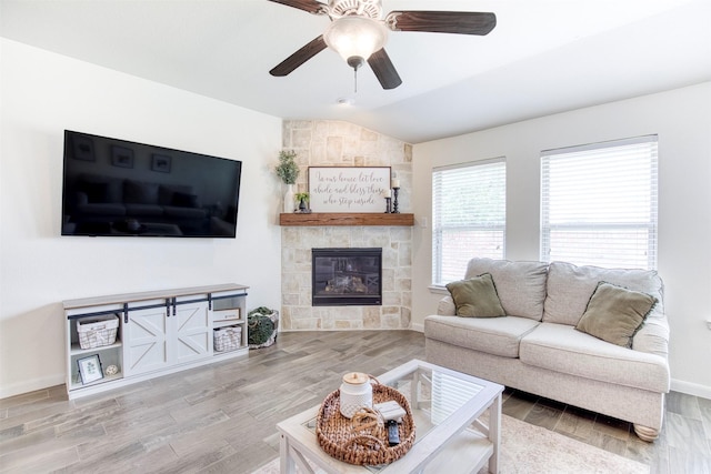 300 Copper Switch Dr, Anna, TX 75409 - living room featuring a large fireplace, baseboards, vaulted ceiling, wood finished floors, and a ceiling fan