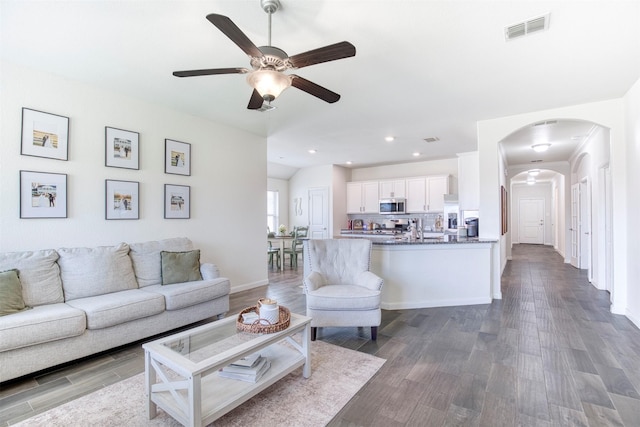 300 Copper Switch Dr, Anna, TX 75409 - living room featuring ceiling fan, visible vents, baseboards, arched walkways, and wood finished floors