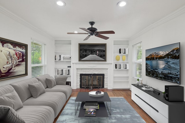 3817 Trail Lake Dr, Fort Worth, TX 76109 - living area with ornamental molding, a ceiling fan, dark wood finished floors, a fireplace, and built in features