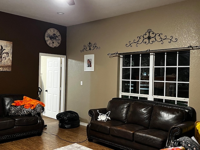 living room featuring baseboards and wood finished floors