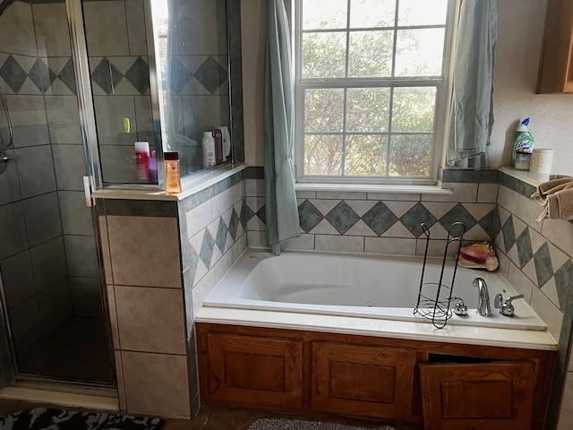 full bath featuring a tub with jets and a stall shower