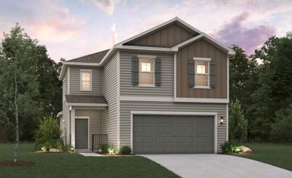 traditional home with a garage, board and batten siding, a yard, and concrete driveway