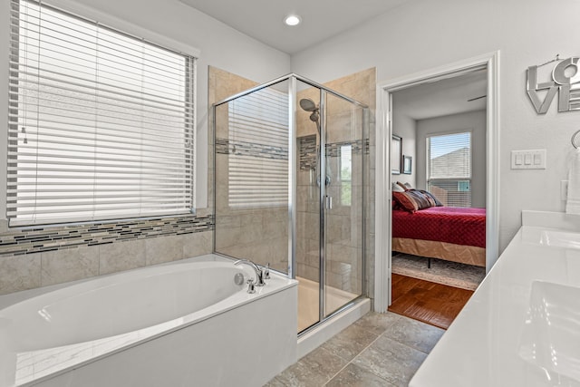 full bathroom with a stall shower, recessed lighting, a bath, and ensuite bath