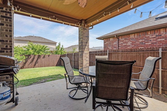 view of patio featuring grilling area, outdoor dining space, and a fenced backyard