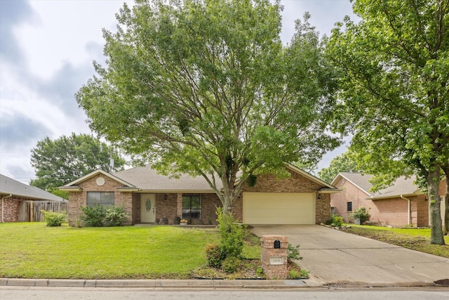 single story home with brick siding, a front yard, concrete driveway, and an attached garage