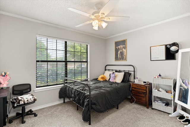 carpeted bedroom with baseboards, ornamental molding, a ceiling fan, and a textured ceiling